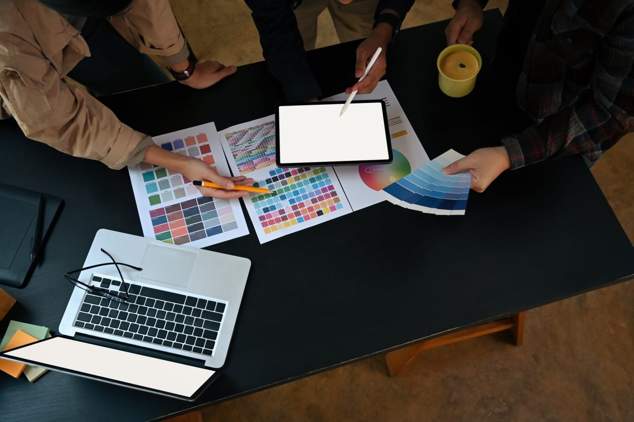 Home 11 overhead view team of graphic designer working with color chart and brainstorming for new project